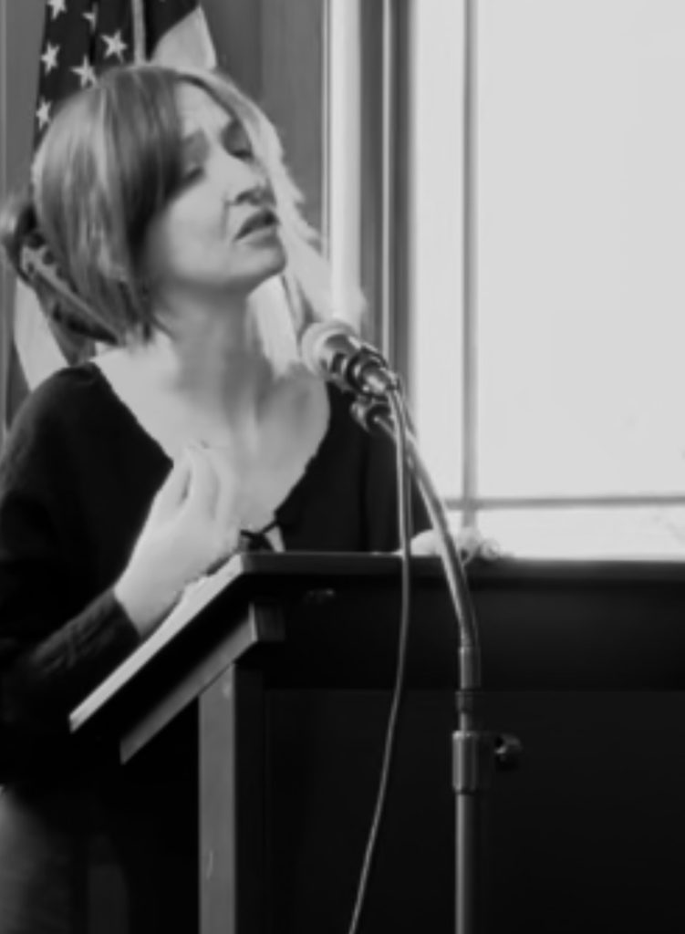 kat. reading poetry at a literary event in New Lenox, Illinois
